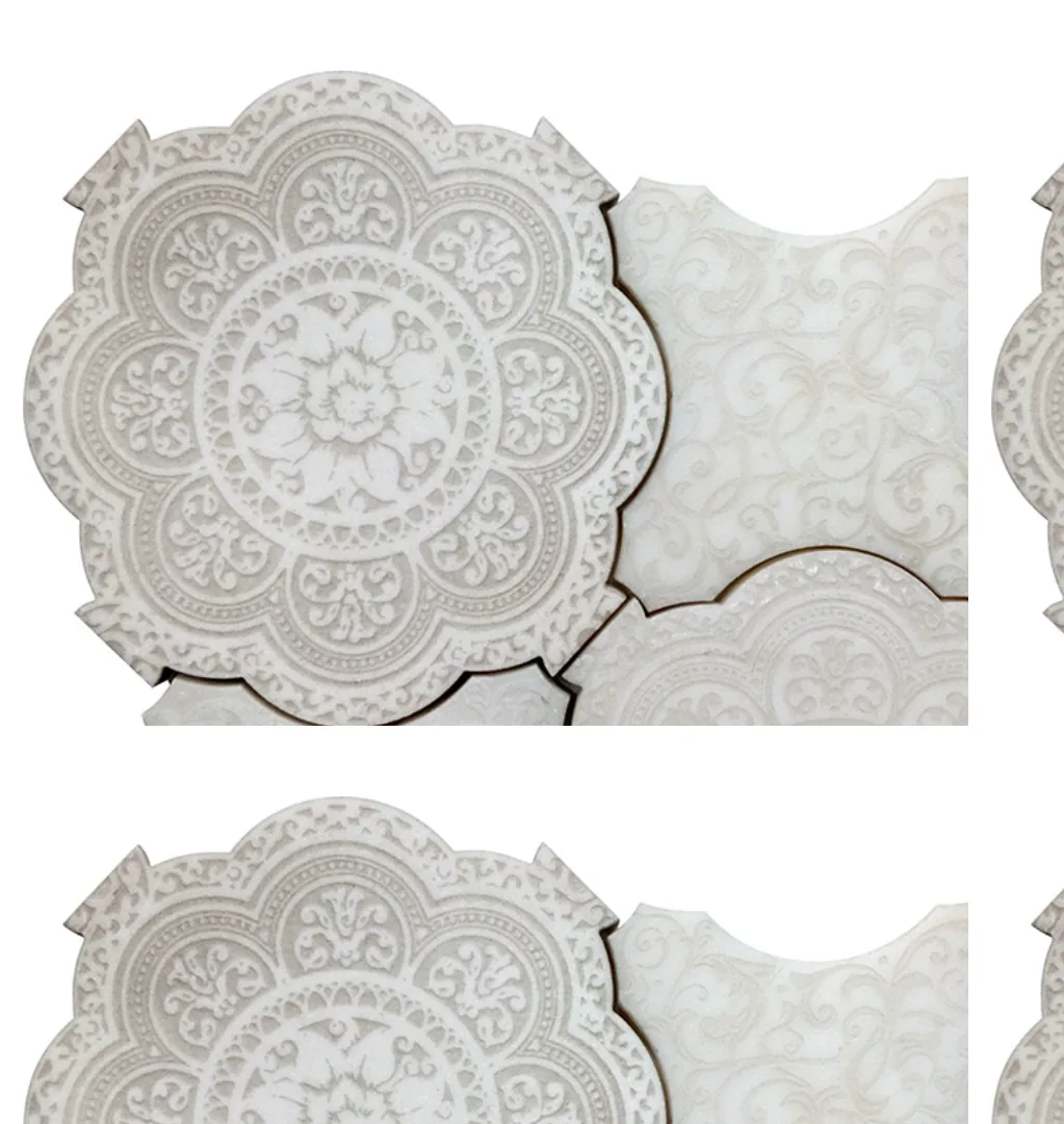 Giardino Bianco marble: the same arabesque medallion carved into white stone, catching a soft raking light.