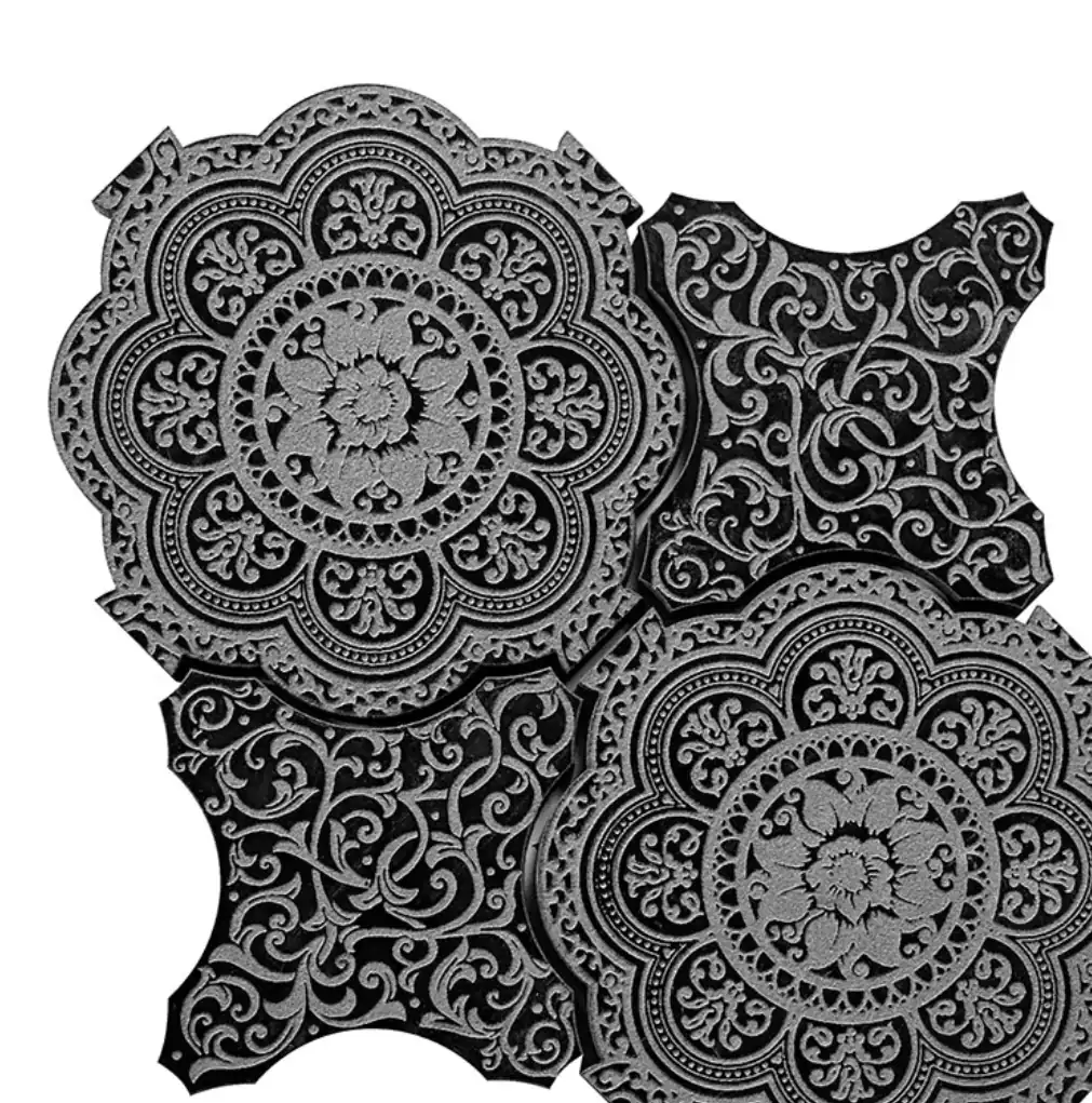 Giardino Nero marble: black stone tiles carved with a fine arabesque medallion, interlocking at the edges.