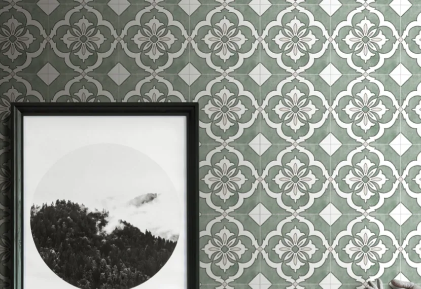 Green and white patterned tile covering a wall behind a framed print.